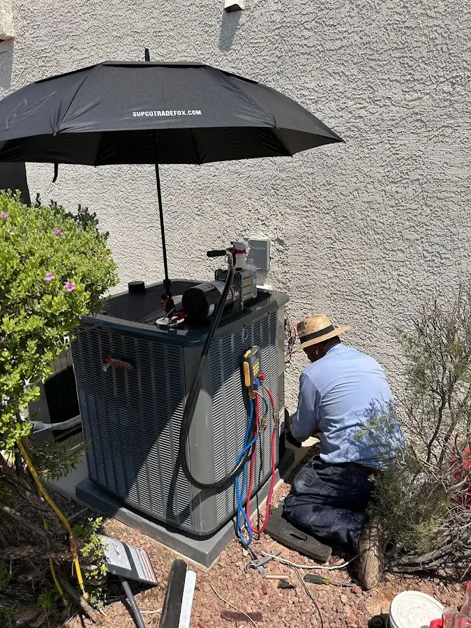 HVAC technician performing outdoor AC maintenance in Cromwell